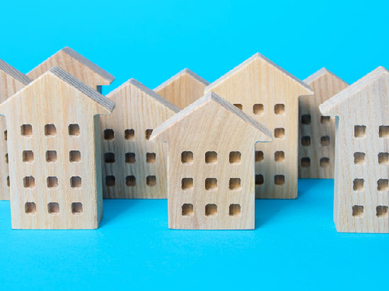 Wooden cutouts shaped like apartment buildings.