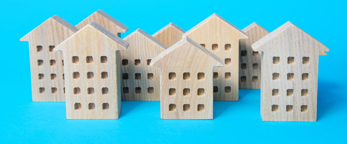 Wooden cutouts representing apartment buildings.