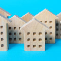 Several wooden cutouts depicting apartment buildings.